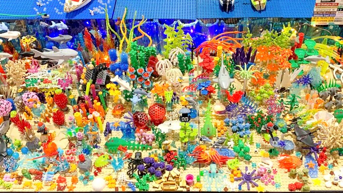 Intricate Lego model of Great Barrier Reef full of colourful sea creatures.