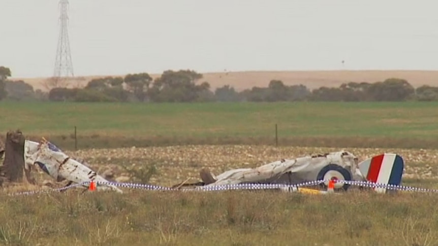 Crumpled wreckage of a light aircraft lies in a paddock