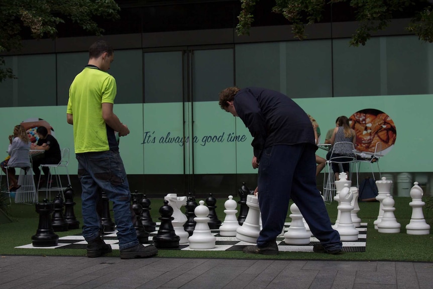 People playing the giant chess board in Central Park Chippendale