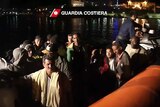 Survivors from an asylum boat sinking are helped by the Italian coast guard