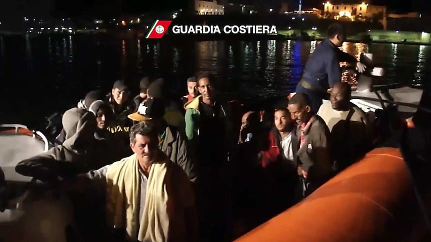 Survivors from an asylum boat sinking near the island of Lampedusa are helped by the Italian coast guard.