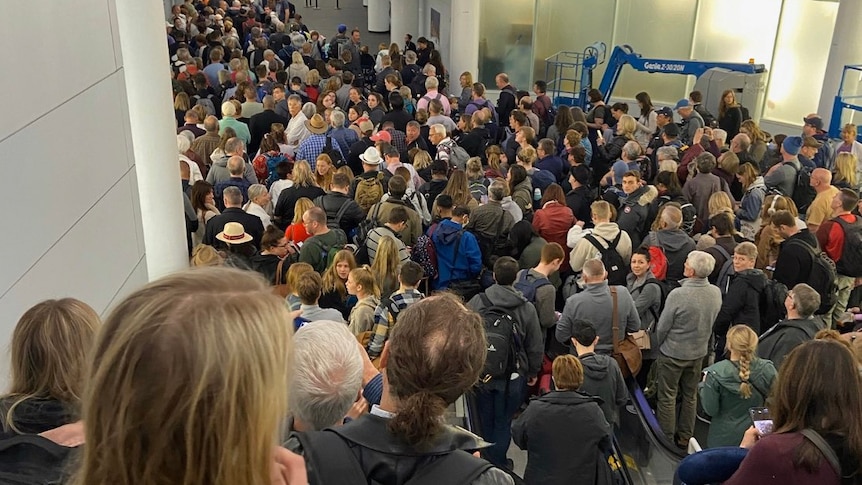 People stand in long queues at Chicago's O'Hare International Airport.