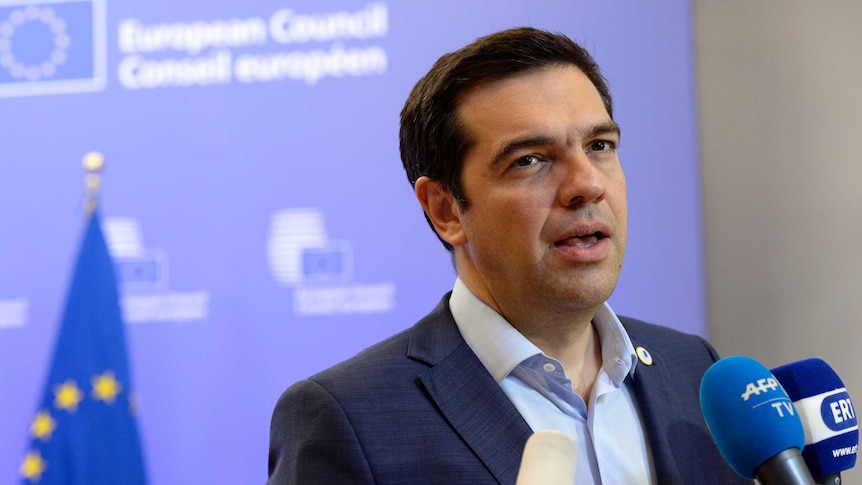 Greek Prime Minister Alexis Tsipras talks to the media at the end of an eurozone summit over the Greek debt crisis.