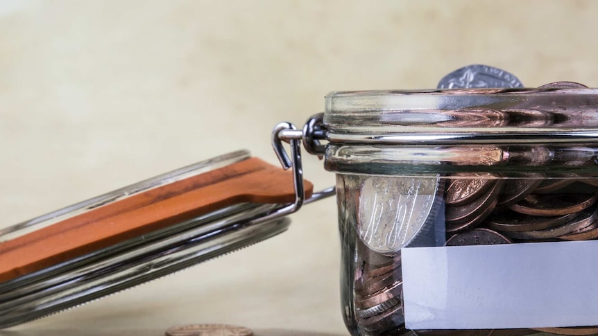 A jar full of money with its lid open