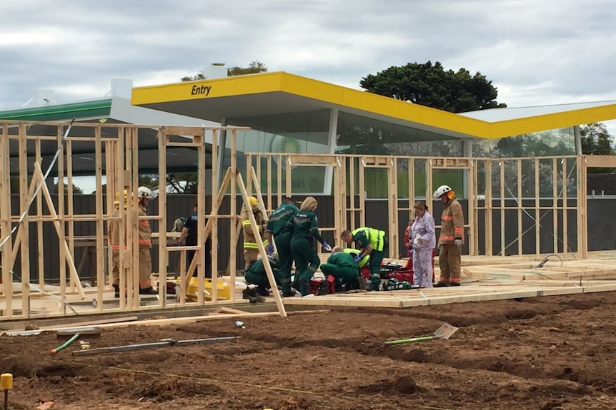 Paramedics attend to an injured person after wall framing apparently collapsed at Fullarton