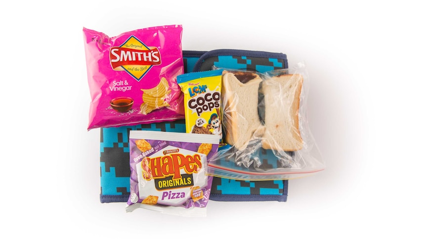 A Nutella sandwich, Coco Pops LCMs bar, salt and vinegar potato chips and pizza-flavoured shapes on top of a blue cooler bag.