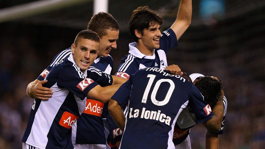 Celebrations from Melbourne Victory players after another goal in their win over Wellington at Docklands.