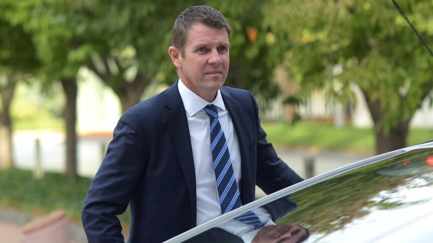 NSW Premier Mike Baird getting out a car.