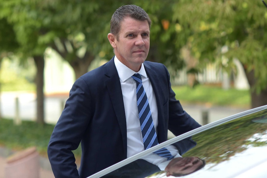 NSW Premier Mike Baird getting out a car.