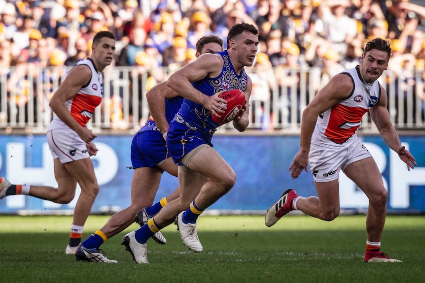 Luke Shuey makes a run with the ball for the Eagles against the Giants.