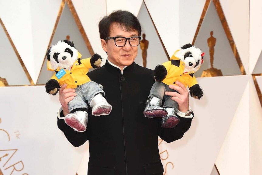 Jackie Chan with toys on the Oscars red carpet