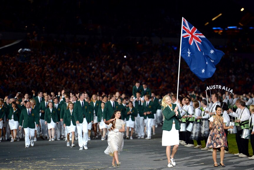 Flagbearer Lauren Jackson leads the Australian team into the stadium.