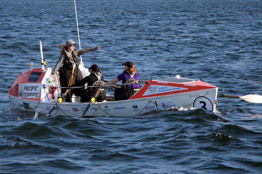 Three women in 7.6m row boat.