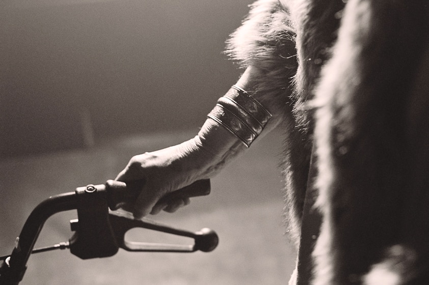 Close up of a wrinkled hand on a the handle of a walker