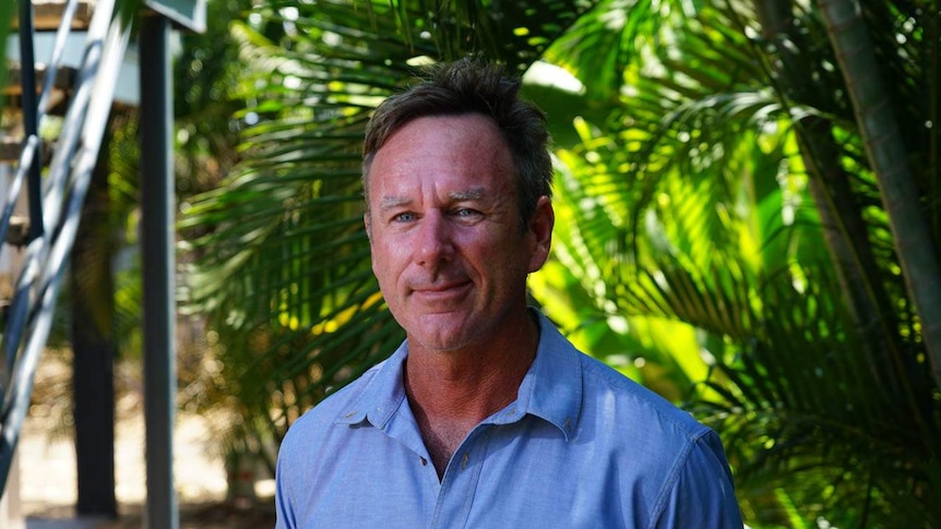 A photo of a man wearing a blue shirt.