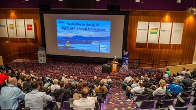 A conference presentation in an auditorium.