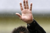 Actor Charlie Sheen gestures towards the media