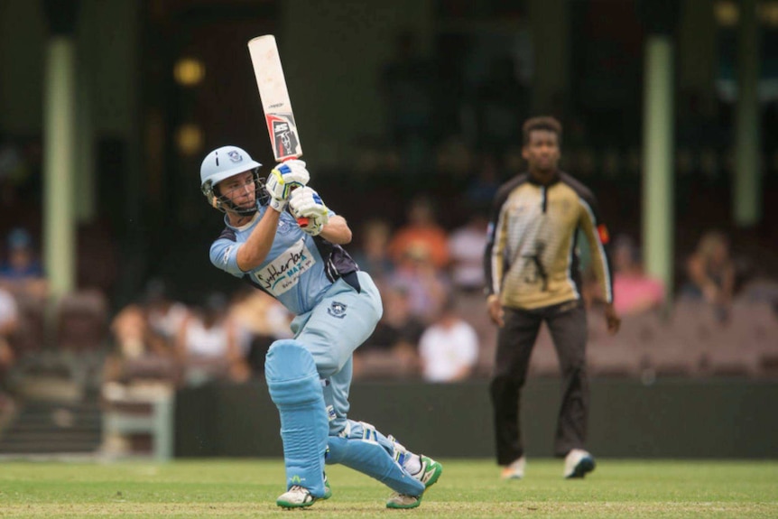 Chris Williams wears the Sutherland team's light blue unifrm as he bats