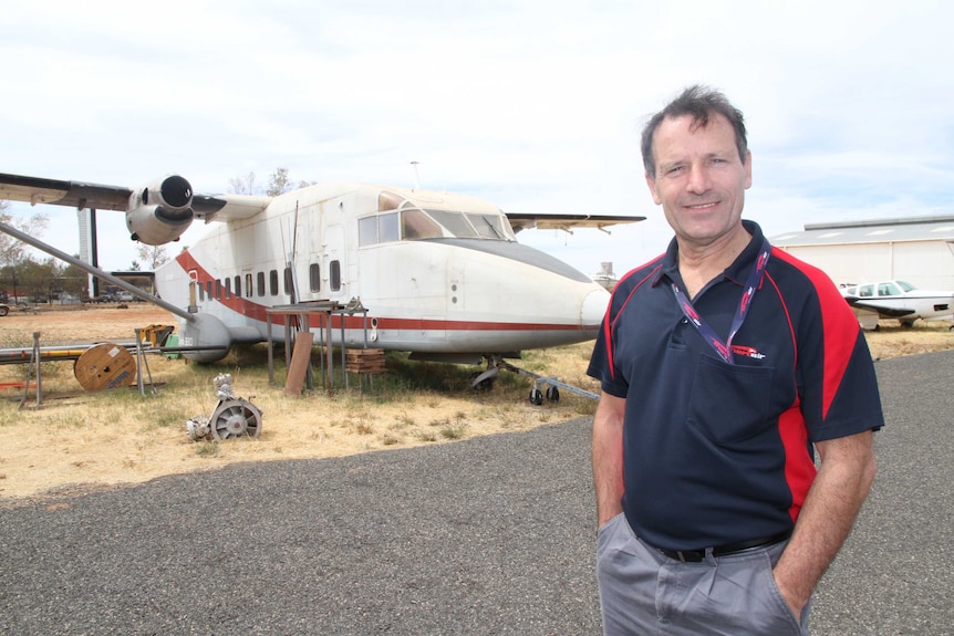 Douglas Hendry standing in front of the old commuter plane