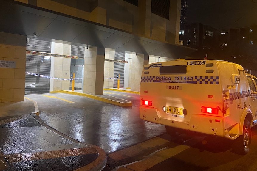 a police van outside a cordoned car park