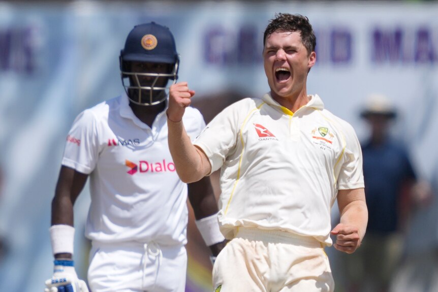 Australia bowler Mitch Swepson punches the air and shouts with glee after taking Dhananjaya de Silva's wicket in the first Test.