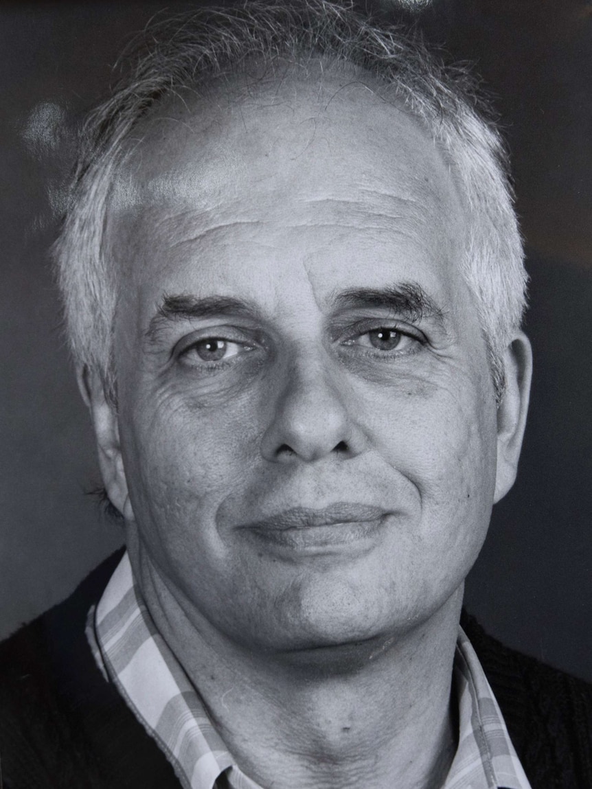 A black and white photo a man with grey hair