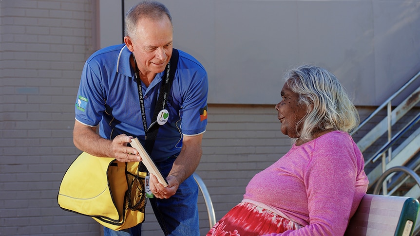 An Australian Bureau of Statistics Field Staff Worker helping an Alice Springs local fill out the Census.