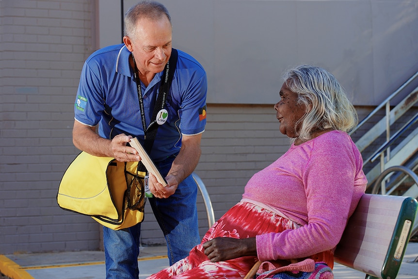 An Australian Bureau of Statistics Field Staff Worker helping an Alice Springs local fill out the Census.