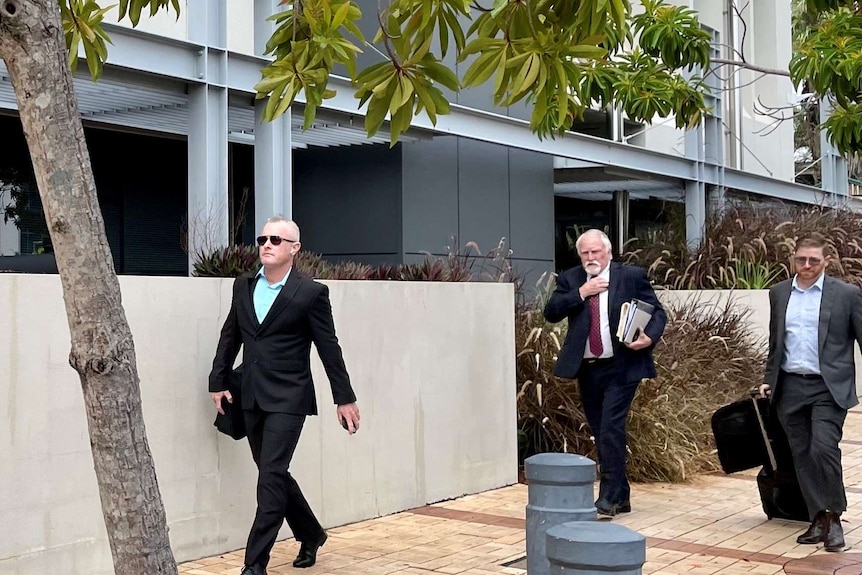 Jayden Moorea (formerly Dan Shearin), left, arrives at the Southport Magistrates Court with his legal team.
