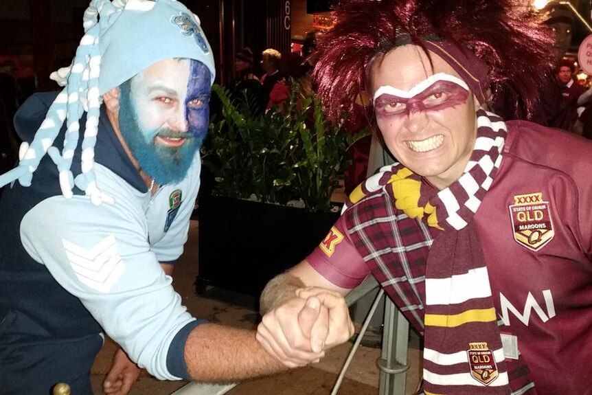 A Blues supporter and a Maroons supporter