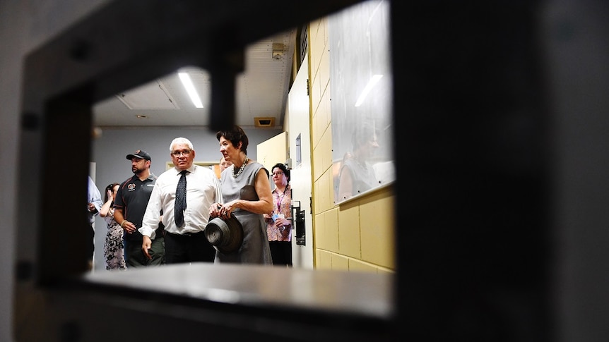 Commissioners Mick Gooda and Margaret White as seen through the bars of Don Dale