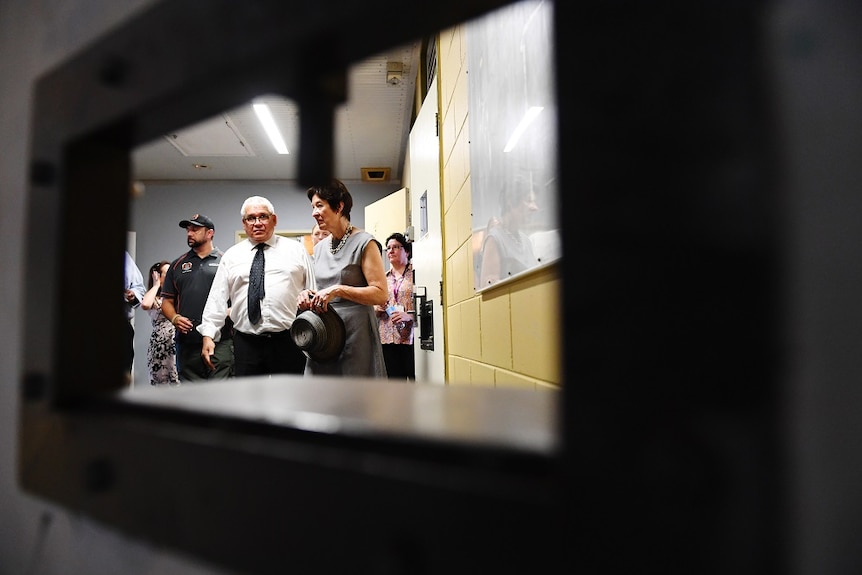 Commissioners Mick Gooda and Margaret White as seen through the bars of Don Dale