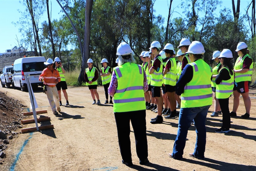 A group of students in hard hats at the Rookwood Weir.