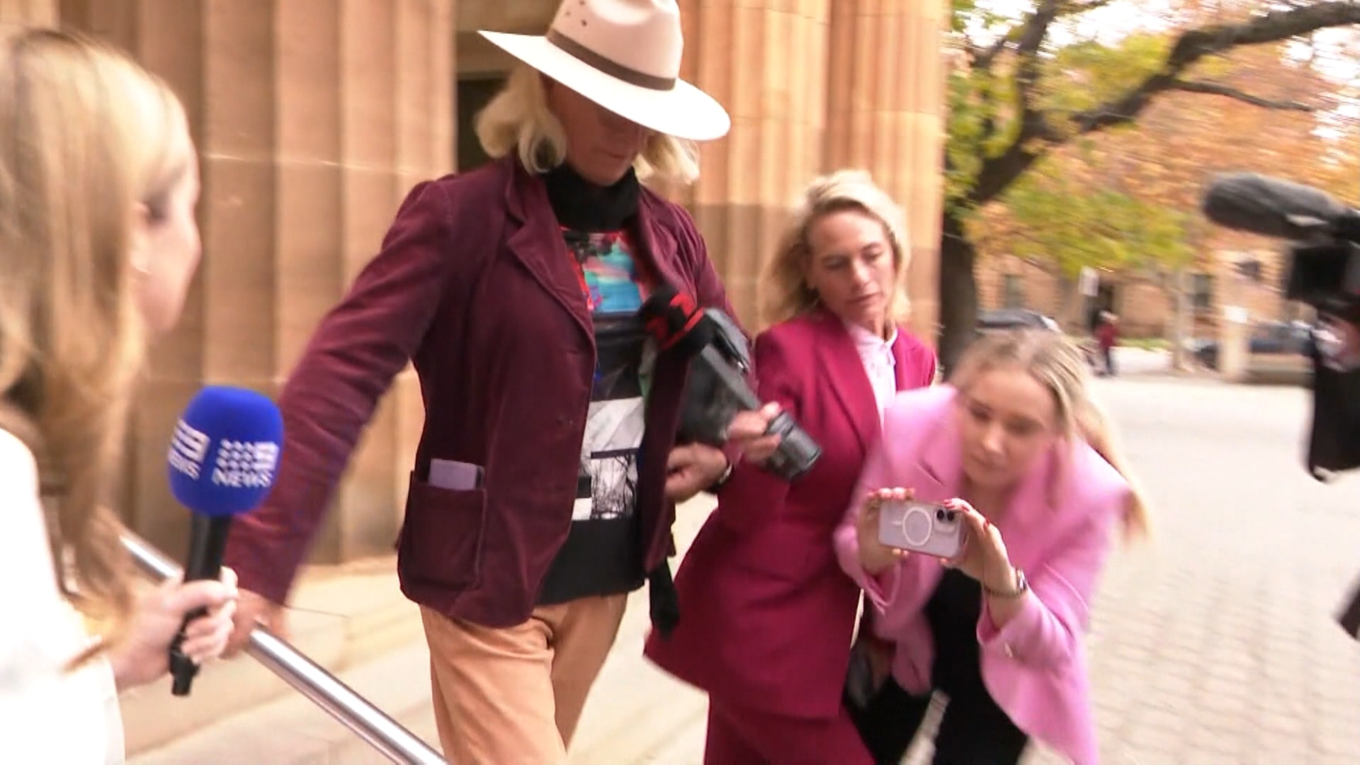 Josie Murray bumping into reporters outside Adelaide Magistrates Court.