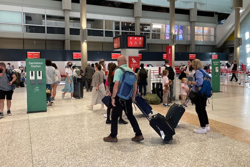 Travellers check in at Brisbane Airport.