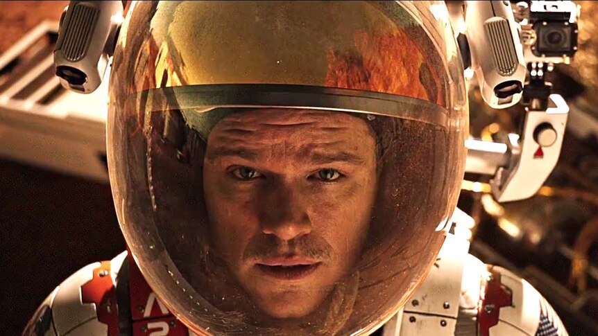 Matt Damon wearing a space helmet in the film The Martian.
