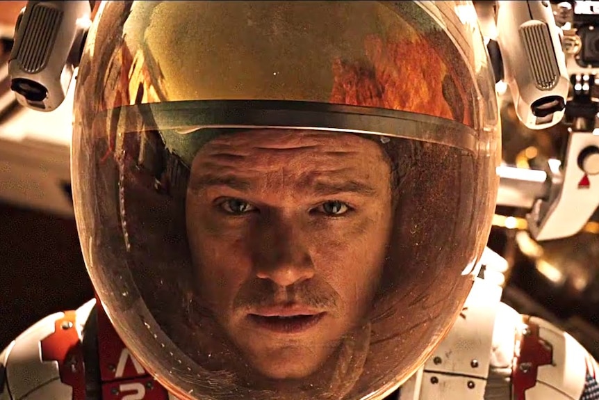 Matt Damon wearing a space helmet in the film The Martian.