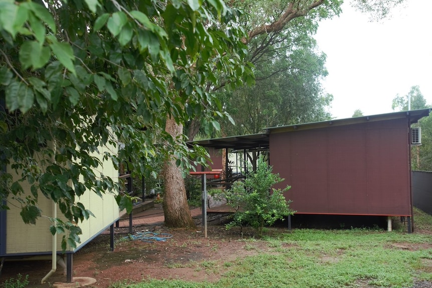 Small cream and red cabins behind a wire fence are where the refugees are being detained at a location near darwin airport