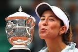 Maiden major ... Garbine Muguruza kisses the French Open trophy after her win over Serena Williams