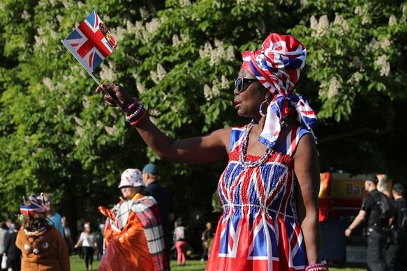 A fan arrives on the Long Walk with flags aplenty.