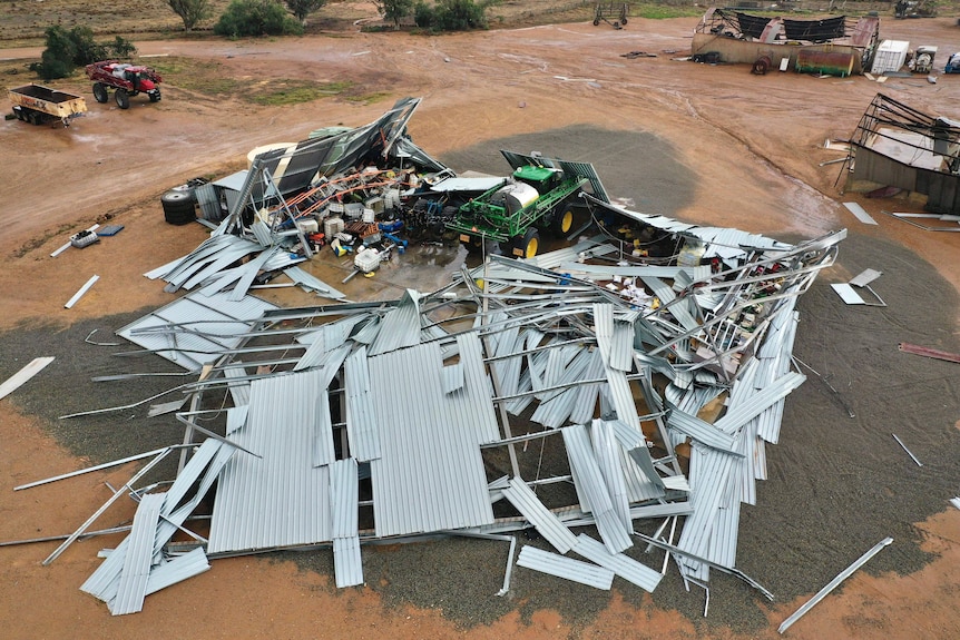 A flattened shed on a farming property.