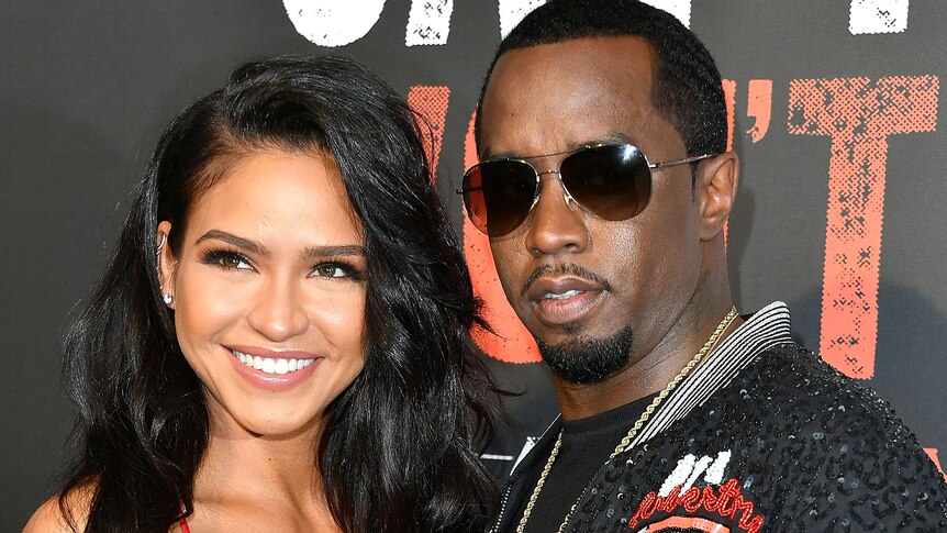 Singer Cassie and Sean Combs pose on the red carpet, Diddy is wearing sunglasses.