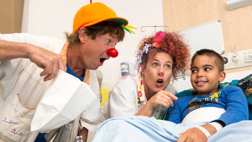Dr Bump and Dr Curly giving a patient at the Royal Darwin Hospital the right dosage of humour.