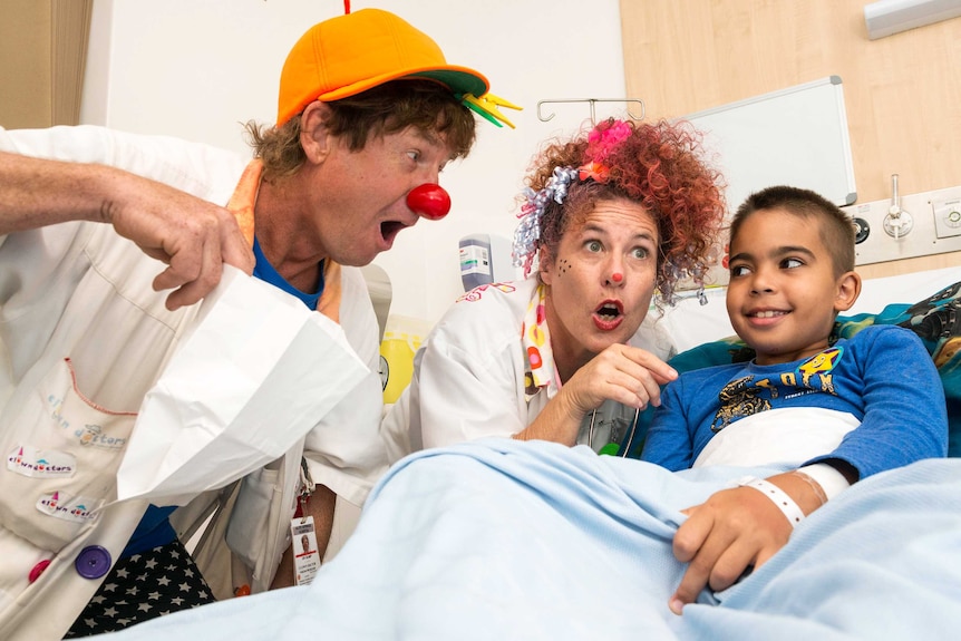 Dr Bump and Dr Curly giving a patient at the Royal Darwin Hospital the right dosage of humour.