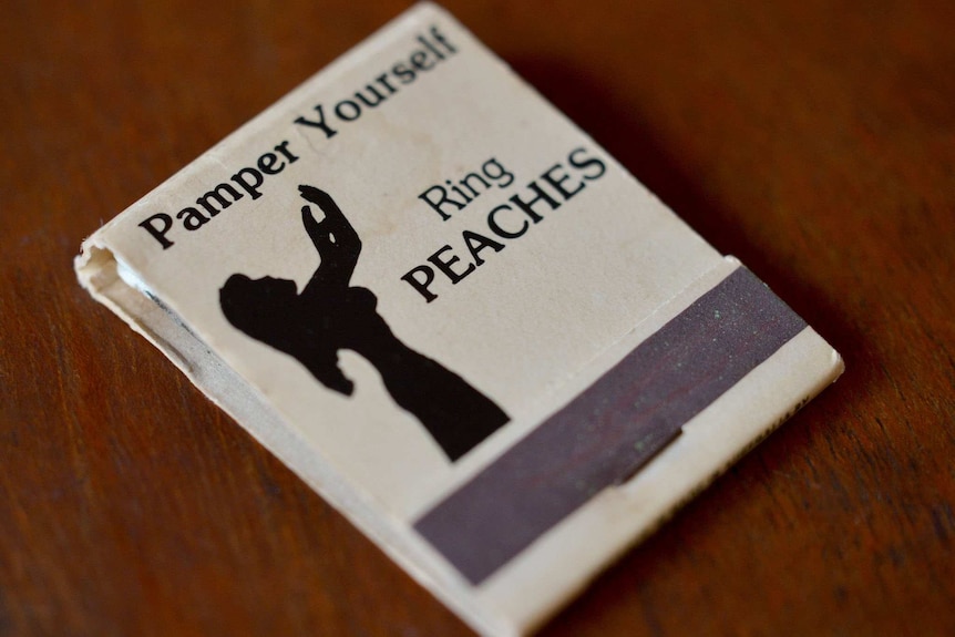 A vintage matchbox depicting a silhouette of a character named Peaches.
