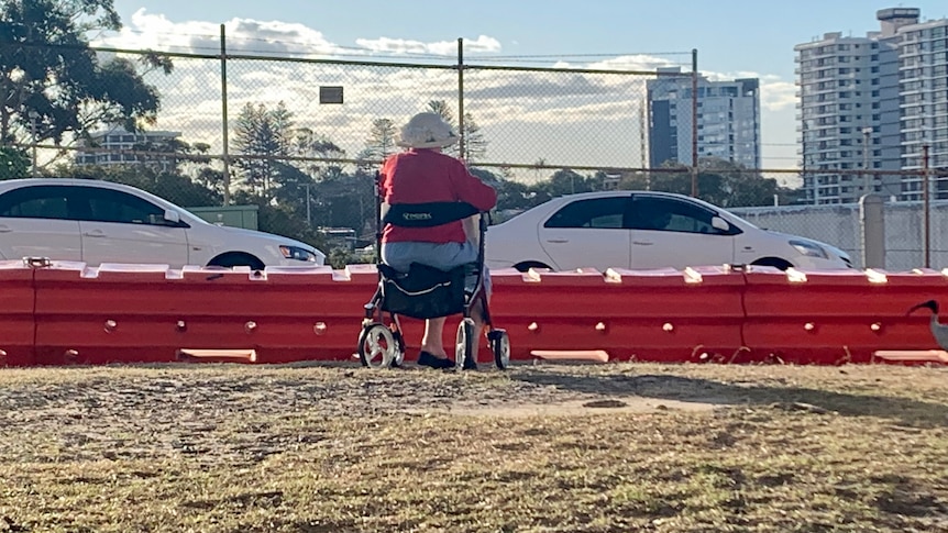 woman sitting on walker at the border