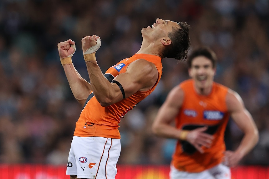 GWS Giant Isaac Cumming leans back as he celebrates a goal against Port Adelaide in an AFL semifinal.