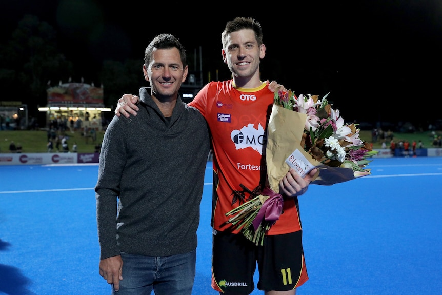 Jamie Dwyer and Eddie Ockenden embrace and pose for the camera