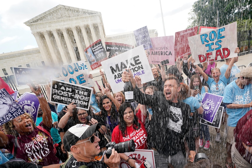 Anti-abortion demonstrators celebrate by popping champagne.
