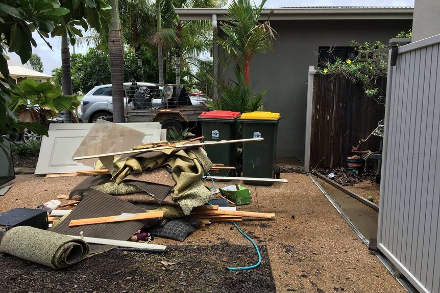 Rubbish outside a house as the mop-up starts at a house in Townsville.